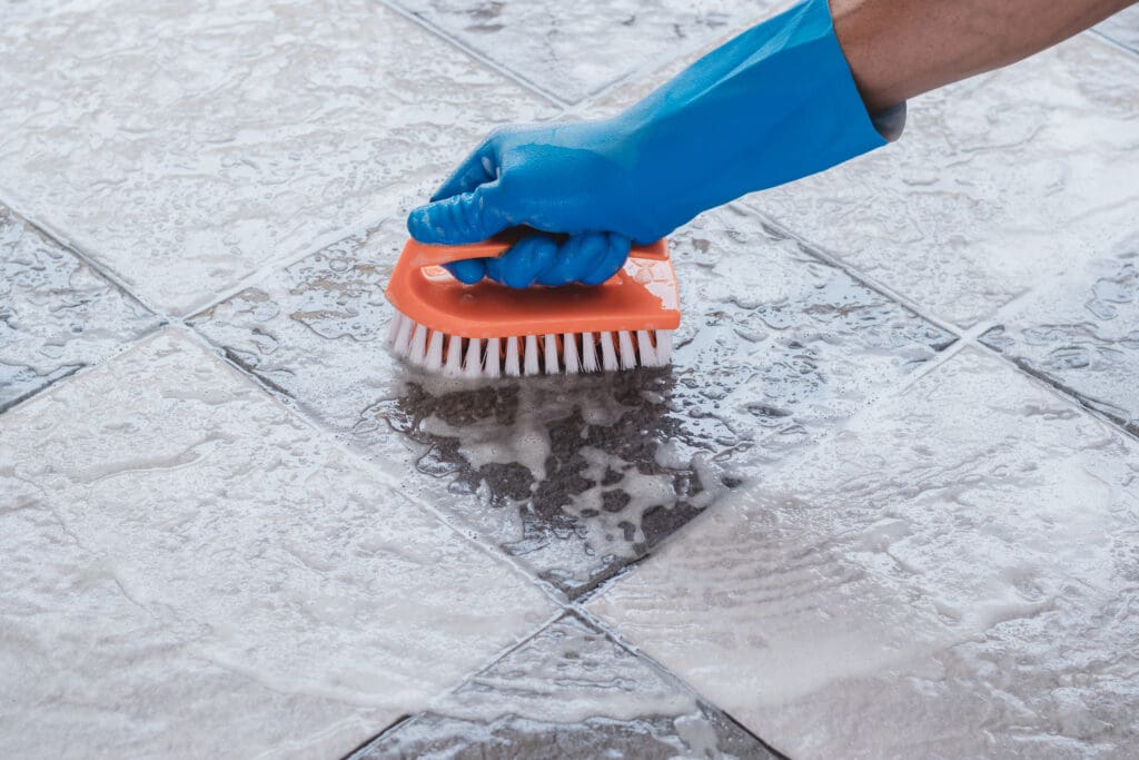 hand-man-wearing-blue-rubber-gloves-is-used-convert-scrub-cleaning-tile-floor