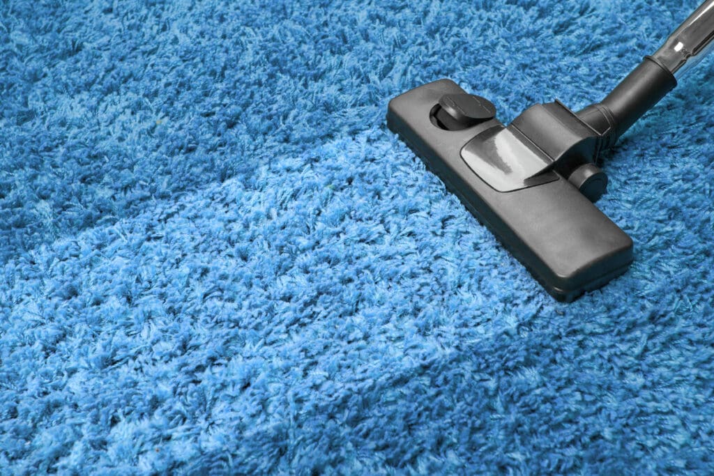 vacuum cleaner on the floor showing house cleaning concept